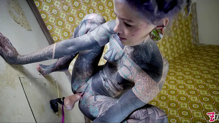 Watch this alternative tattooed babe play with a huge toy for some hot solo action